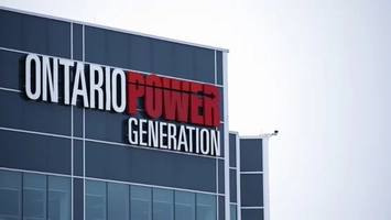 Low-angle view of Ontario Power Generation headquarters with large illuminated signage on a glass facade